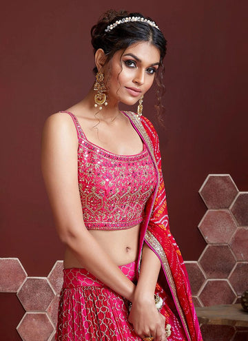 Rani pink chinon silk lehenga choli for party functions with printed dupatta. This indian designer pink lehenga is beautified with thread sequence embroidery work and its also comes with banglory silk real mirror thread embroidery work pink choli. This pink lehenga choli was completed with designer chinon silk bandhej print shaded dupatta.